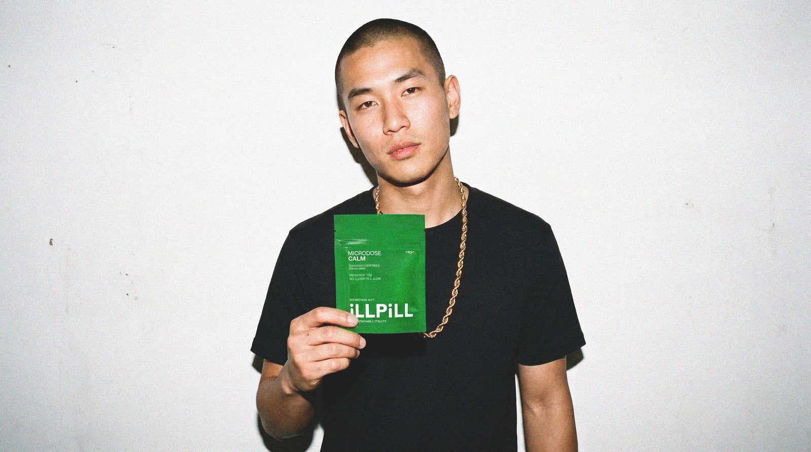 Model holding an iLLPiLL MicroDose Calm pouch